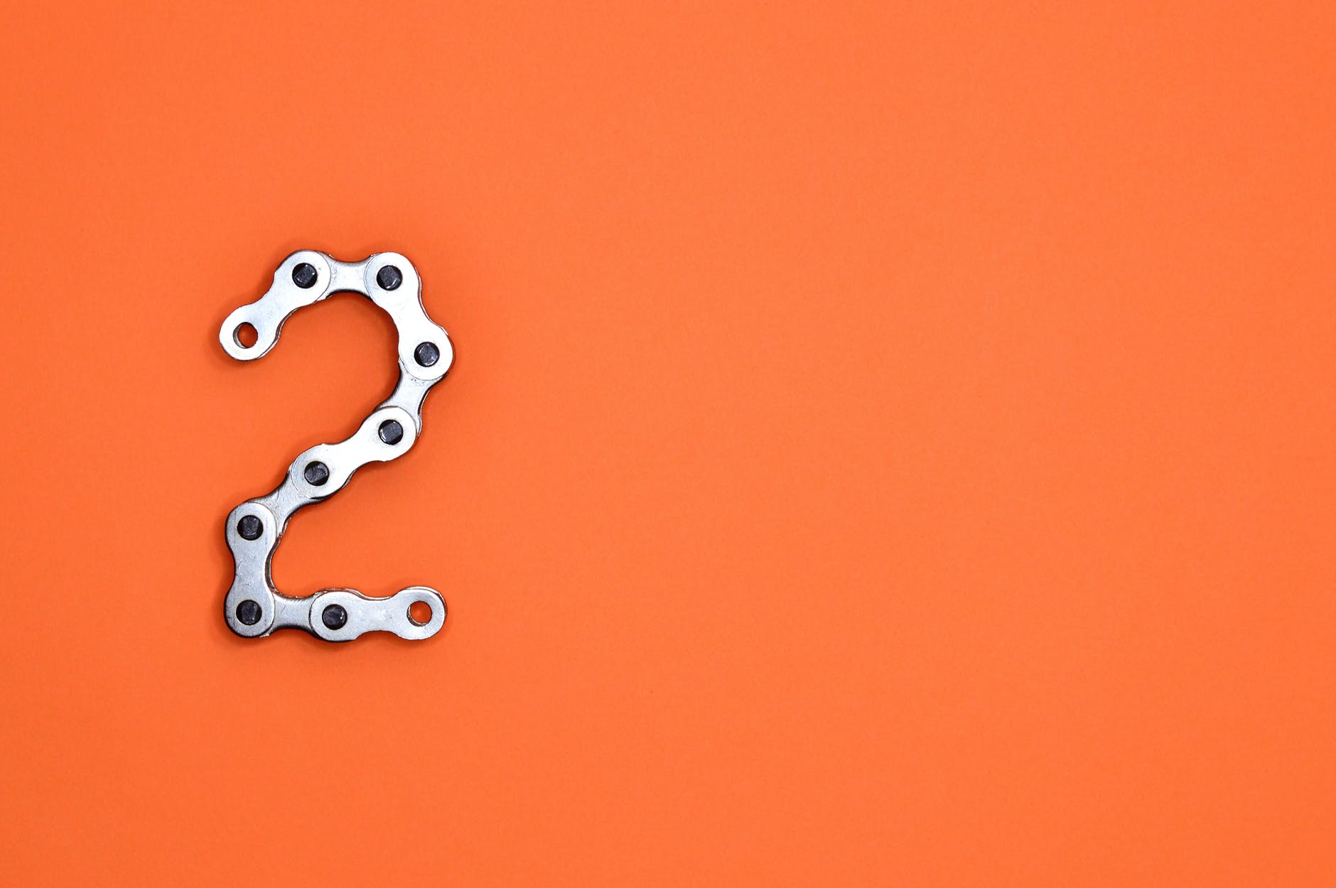 gray steel chain on orange surface